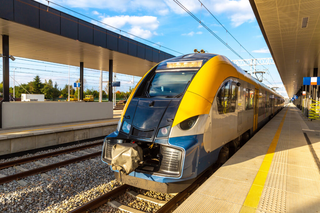 Oswiecim train station in poland with yellow train pulled into the station