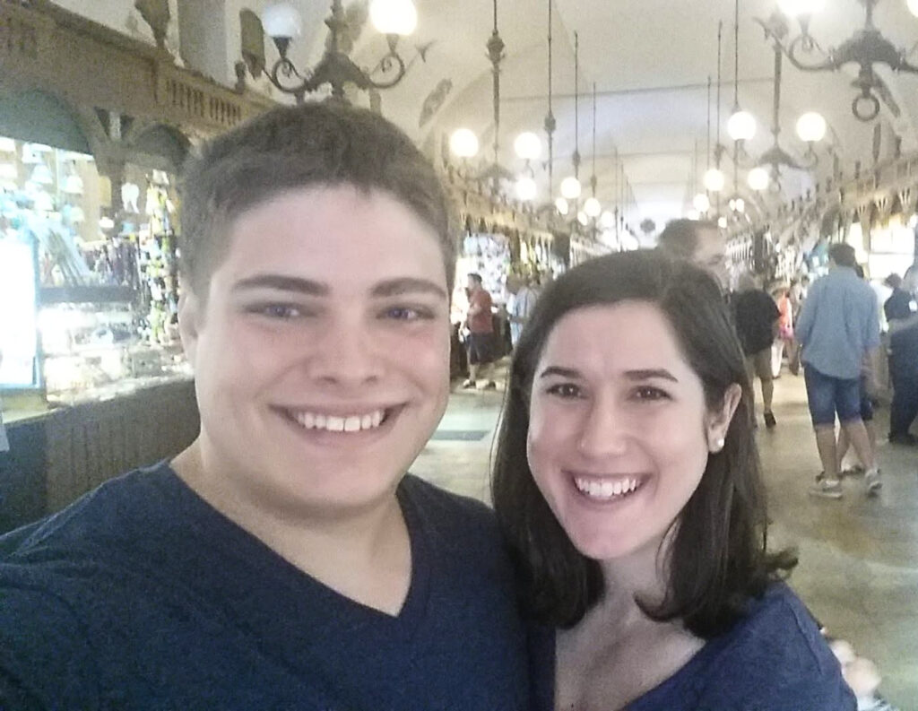 kate storm and jeremy storm taking a selfie inside cloth hall when traveling to krakow poland