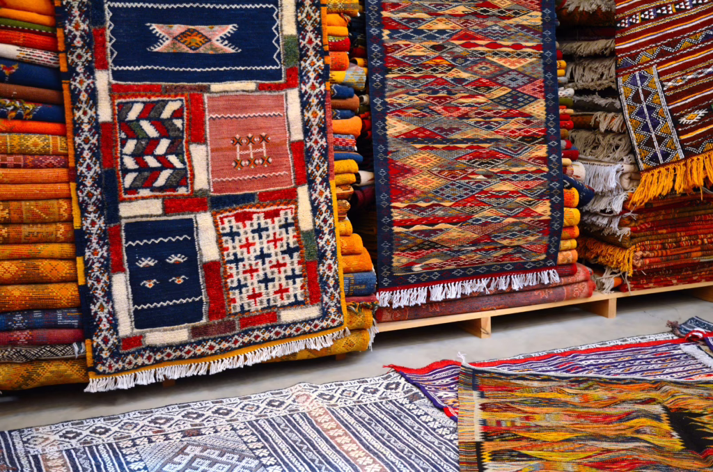 collection of berber carpets for sale in a morocco carpet shop