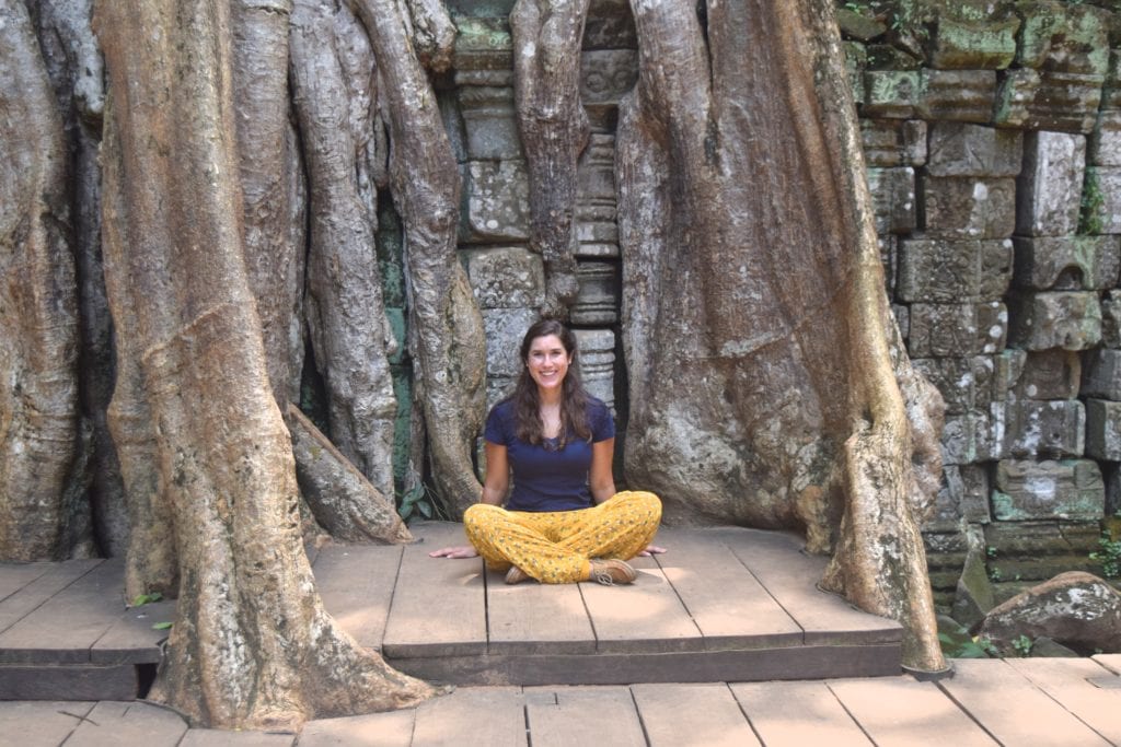 kate storm sitting under a temple in angkor wat cambodia