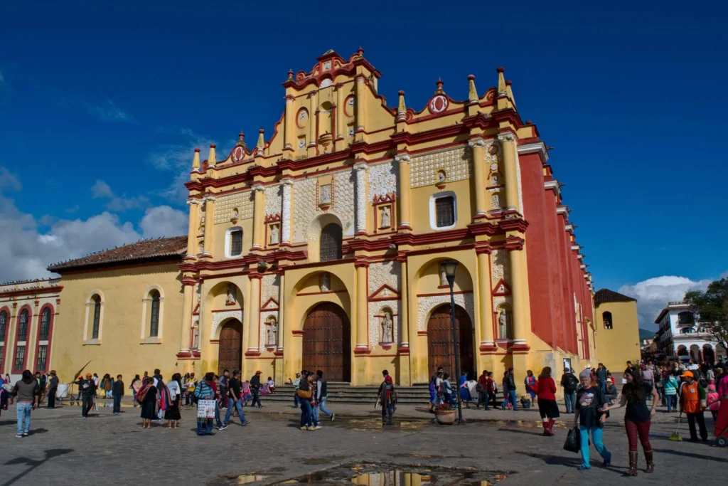 front facade of a bright yellow church in san cristobal de las casas, one of the best stops on a mexico backpacking route