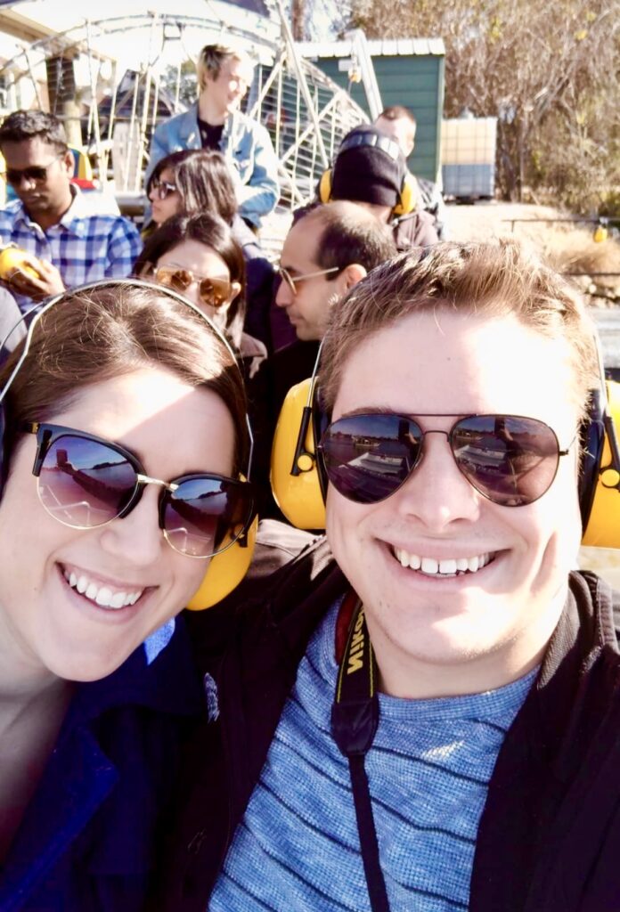 kate storm and jeremy storm taking a selfie on an airboat in the bayou near new orleans