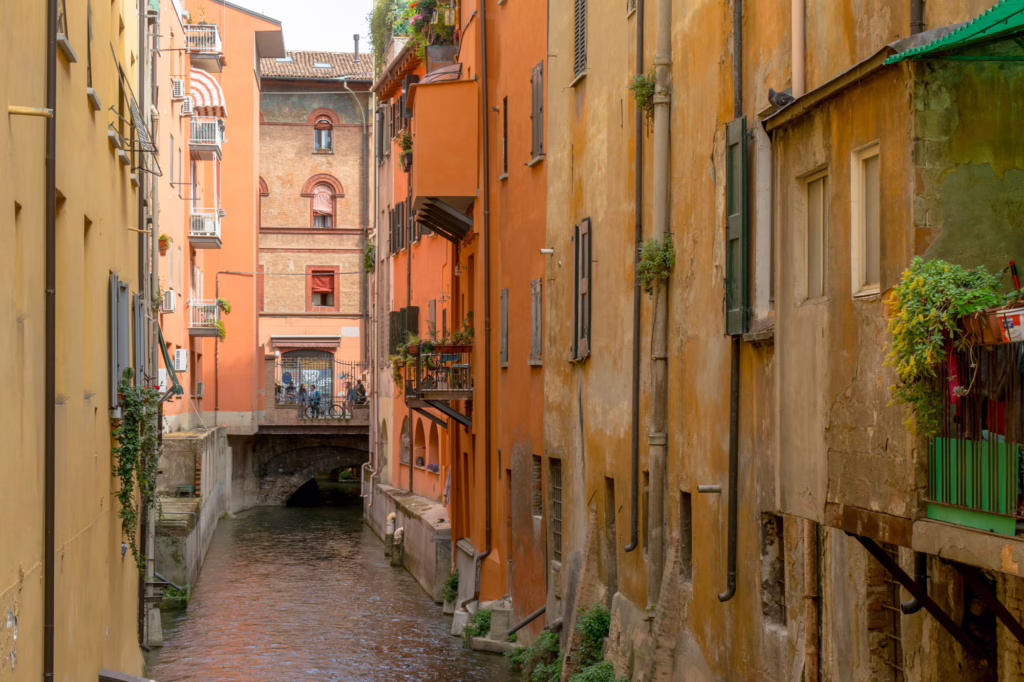 one of the hidden canals of bologna lined with yellow and orange buildings, one of the best things to do in bologna italy is seek them out