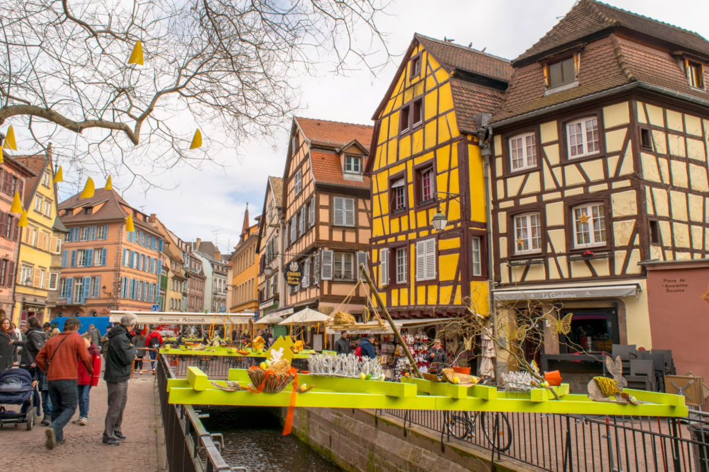 easter and spring market decor in colmar france set up over a canal in la petite venise colmar france on a cloudy day