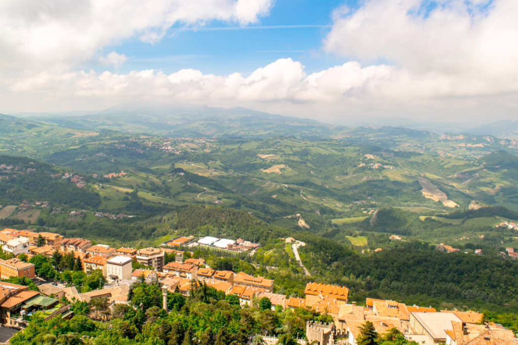 view of san marino from mount titano on a partly cloudy day, viewpoints are one of the best things to do in san marino italy's microstate neighbor