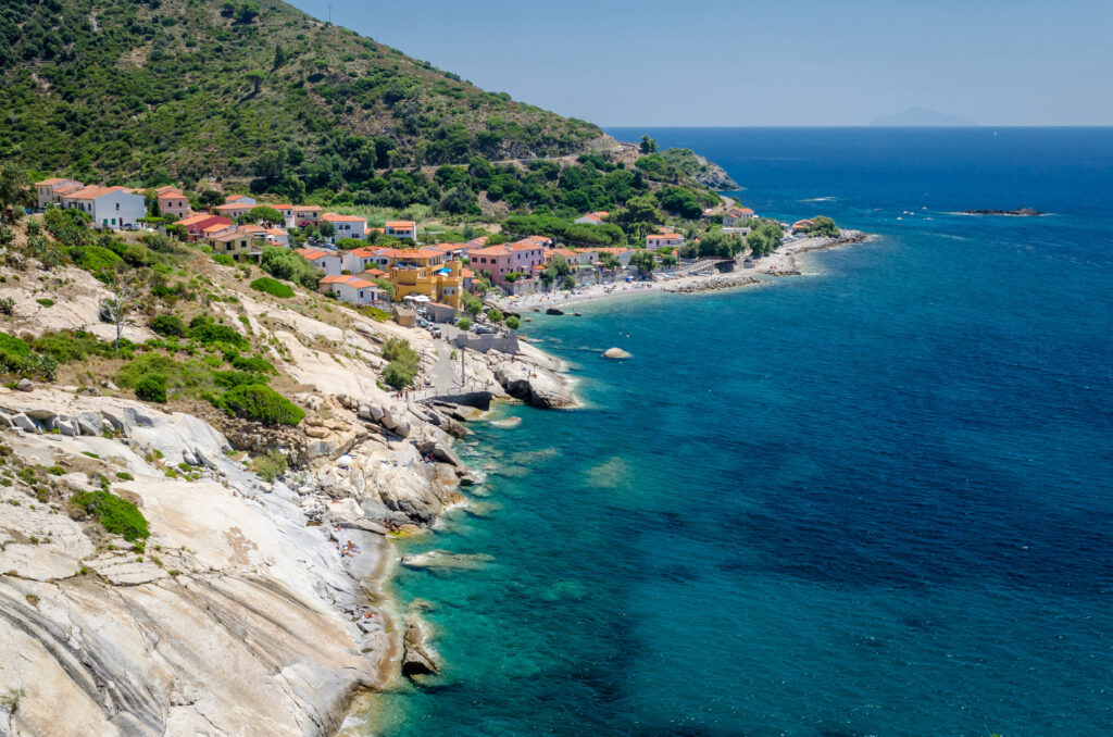 coast of elba tuscany island with village and cliffs visible to the left and sea visible to the right