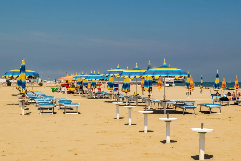 rimini beach with umbrellas and sun chairs set up, one of the best day trips from bologna italy