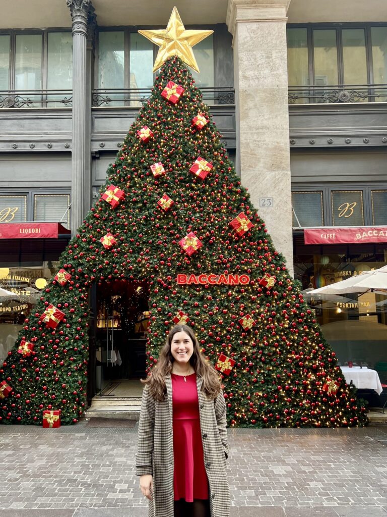 kate storm standing in front of christmas tree style decor when visiting rome in december