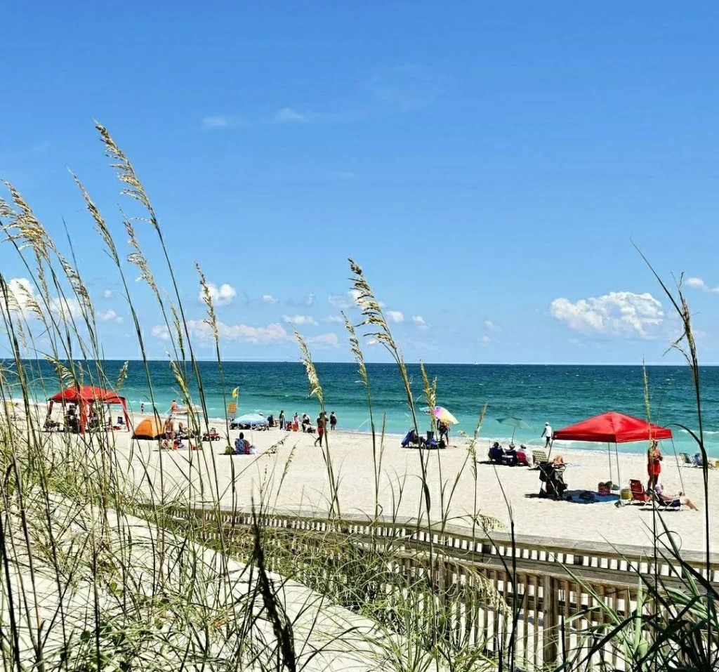 fort macon beach as seen through the sand dunes on a summer dra