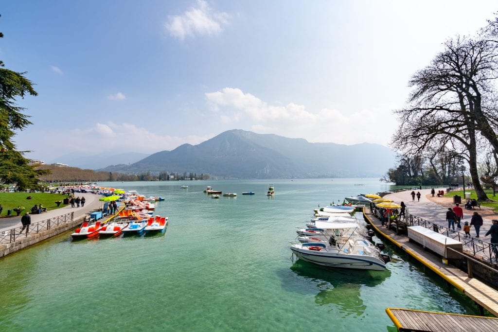 paddleboats and other small watercraft on the shores on lake annecy france