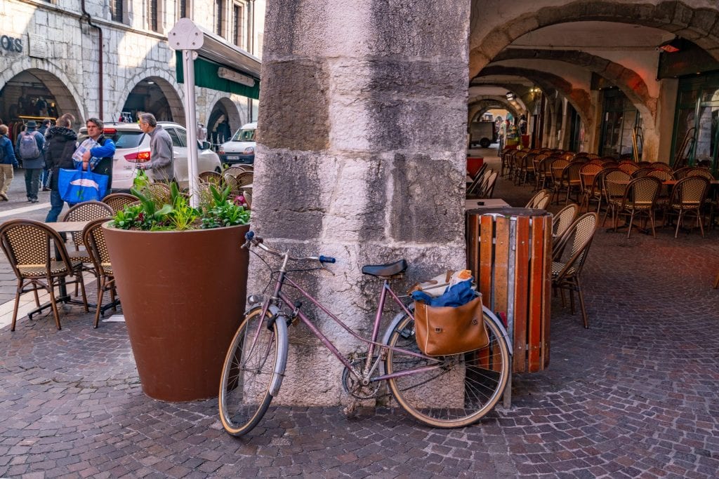 bike parked in annecy france with loaves of bread in a leather satchel attached to the bag