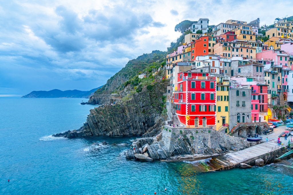 view of riomaggiore with the sea visible on the left near sunset at cinque terre italy