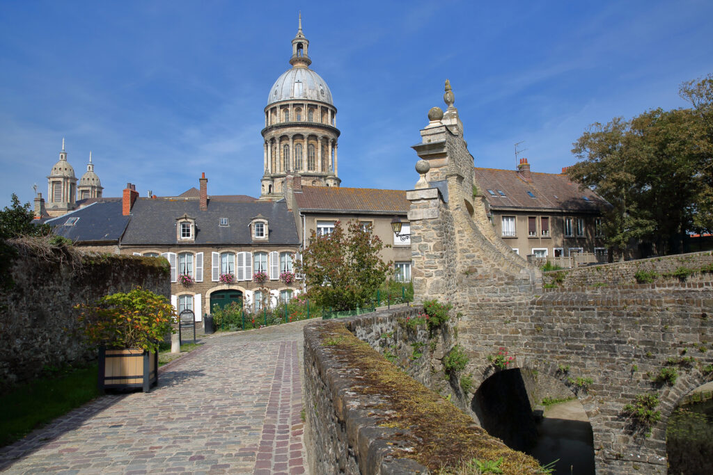 view of entrance to castle museum from stone bridge in boulogne france with cathedral dome visible in the bathroom, a fun stop on an opal coast road trip france