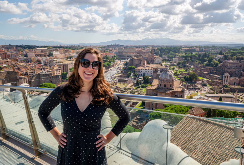 Kate Storm in a gray dress on top of the Altar of the Fatherland in Rome
