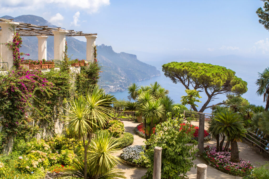 view of the gardens of villa rufalo in ravello italy with ruin visible on left side of the photo, a wonderful stop when visiting the amalfi coast italy