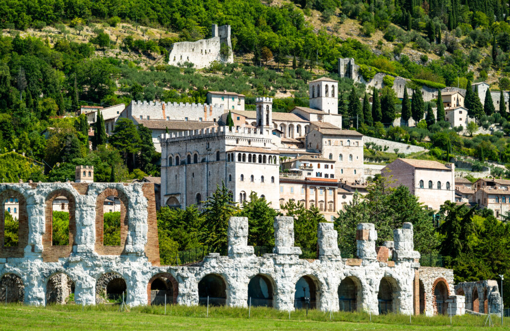 view of gubbio umbria italy from outside the town, with roman theater in the foreground