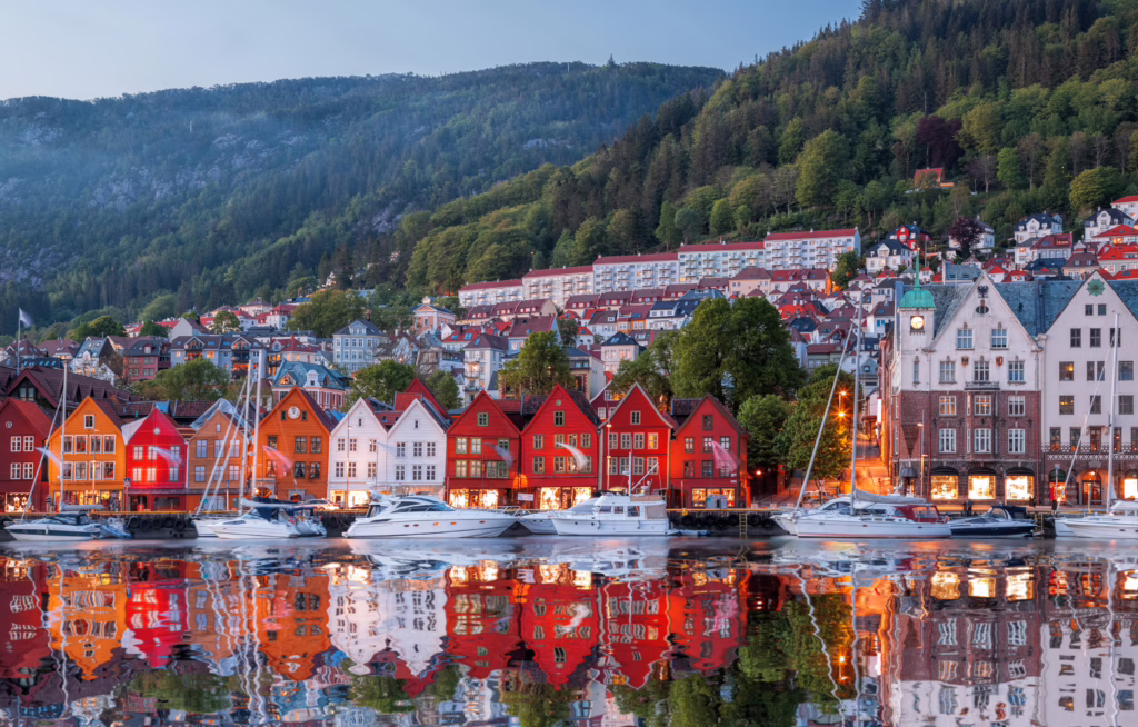 view of colorful homes of bergen norway from the water at night