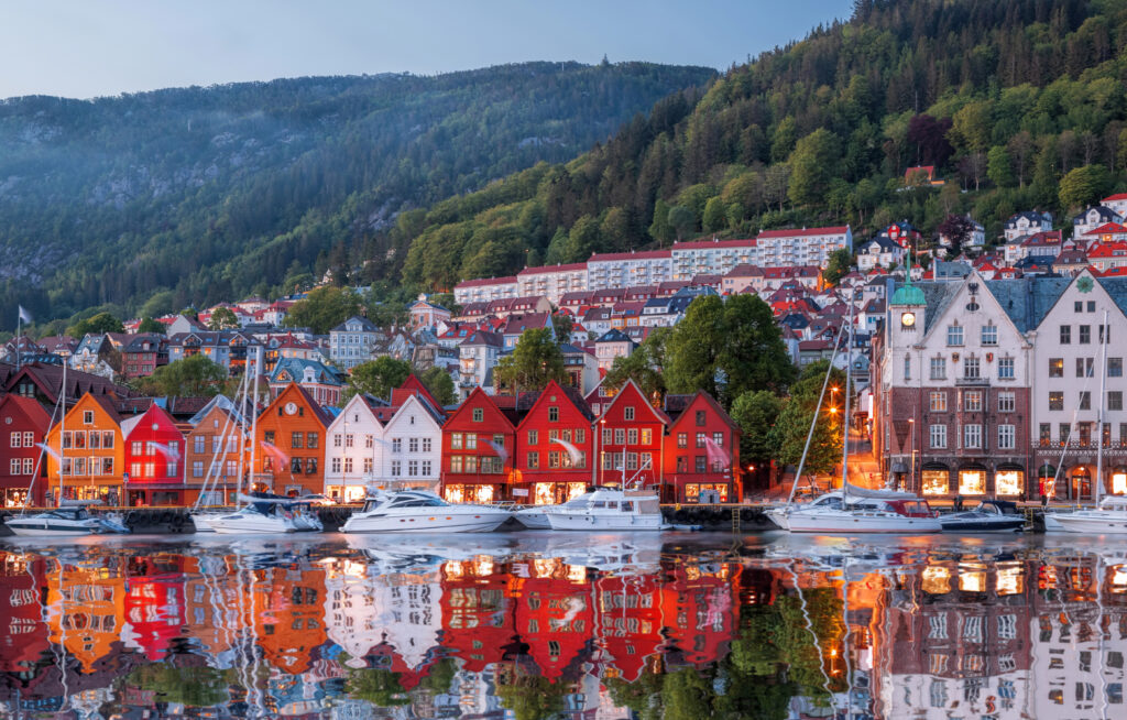 view of colorful homes of bergen norway from the water at night