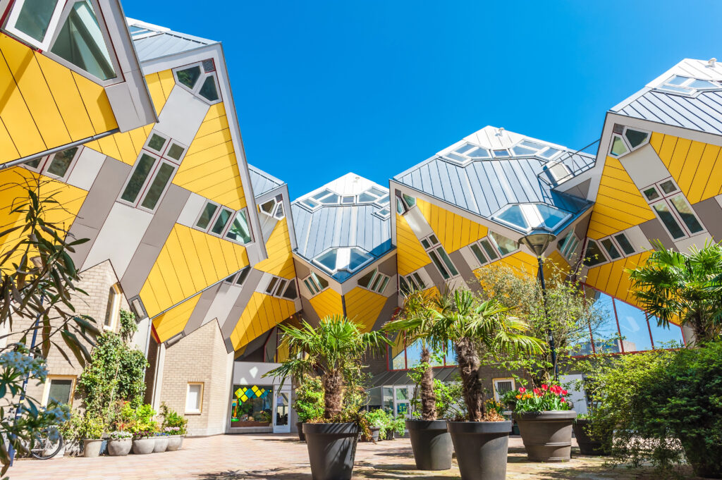 photo of yellow cube houses in rotterdam on a sunny day, one of the best cities to visit in europe off the beaten path