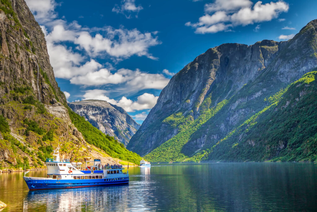 view of gudvengen fjord in western norway with a boat visible in the foreground