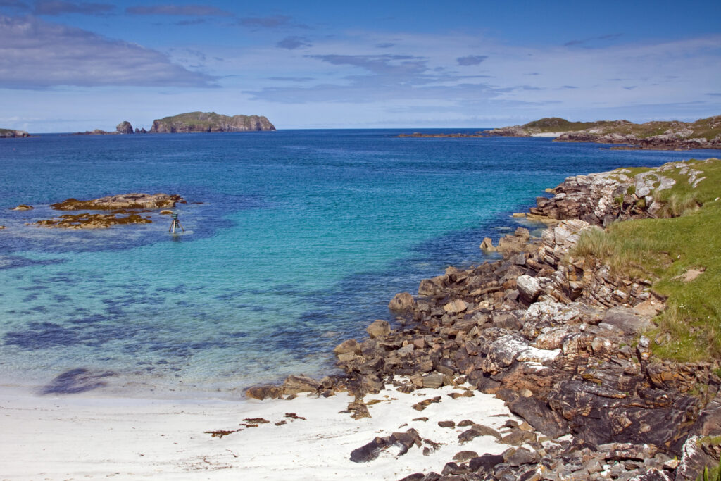 bright blue water on a white sand beach on the isle of lewis scotland places to visit 