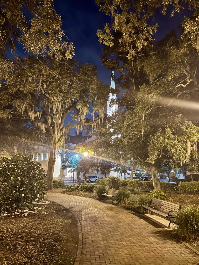 chippewa square in savannah georgia at night with church steeple visible in the background