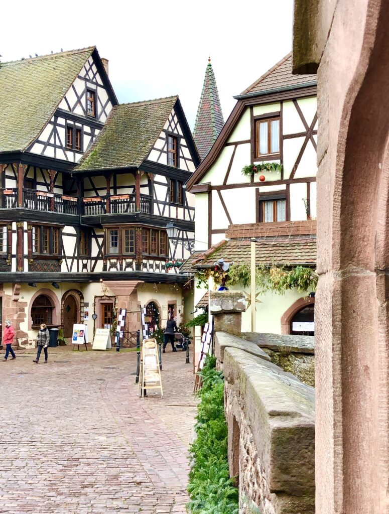 photo of half timbered houses on a cobblestone street in kaysersberg alsace at christmas