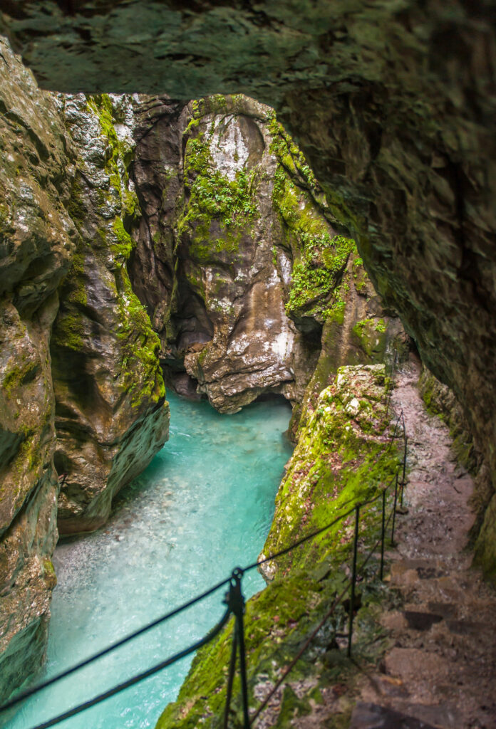 tolmin gorge slovenia as seen from hiking trail, with roped off edge in foreground of the photo