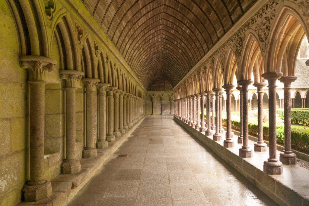 cloister of abbey of mont saint michel with arches lining both sides