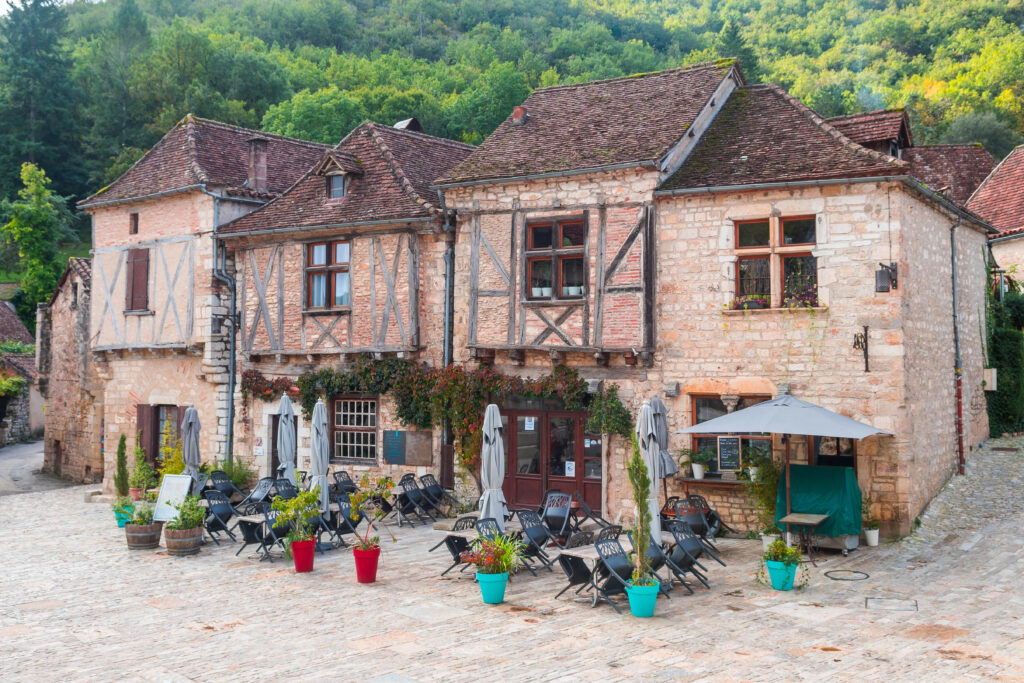 medieval half-timbered buildings along a cobblestone street in saint cirq lapopie one of the best france small towns to visit