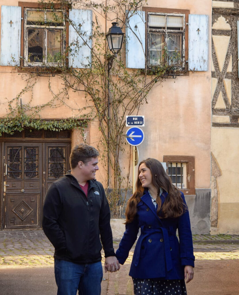 kate storm and jeremy storm holding hands on a side street when visiting colmar france