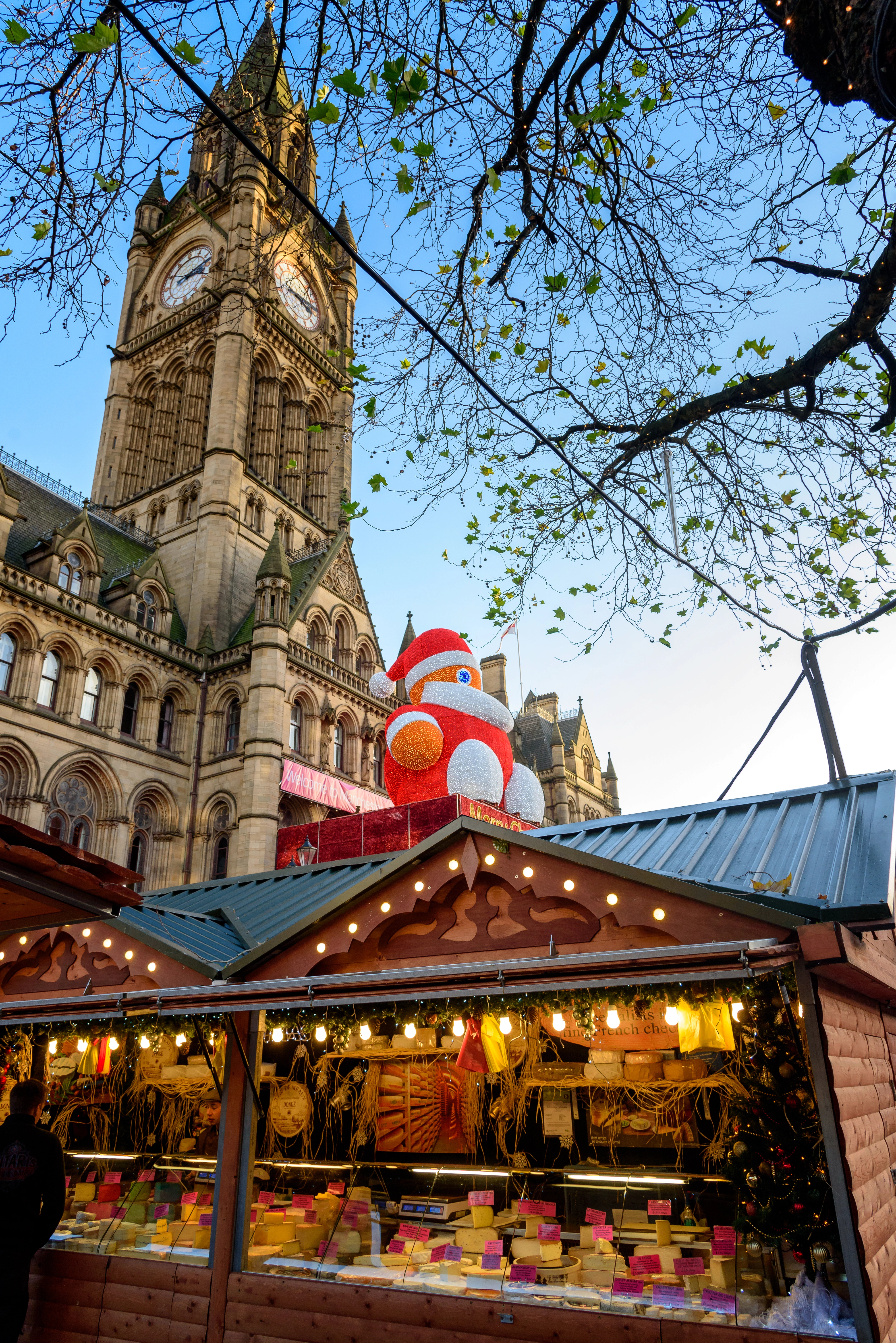 christmas market stall in manchester england underneath clock tower