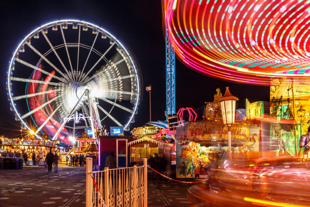 ferris wheel and carousel at hyde park christmas fair, one of the best places to visit in london at christmas