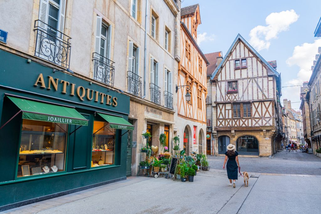 kate storm and ranger storm walking along an empty street featuring half timbered houses in dijon france
