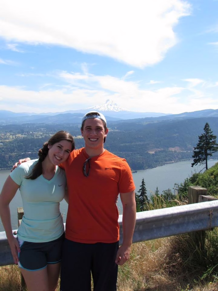 kate storm and her younger brother on the side of the road overlooking columbia river gorge and mount hood