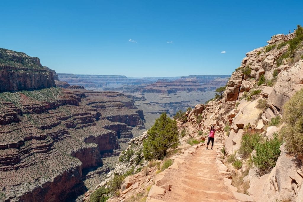 kate storm in a pink shirt hiking into the grand canyon on the south kaibab trail