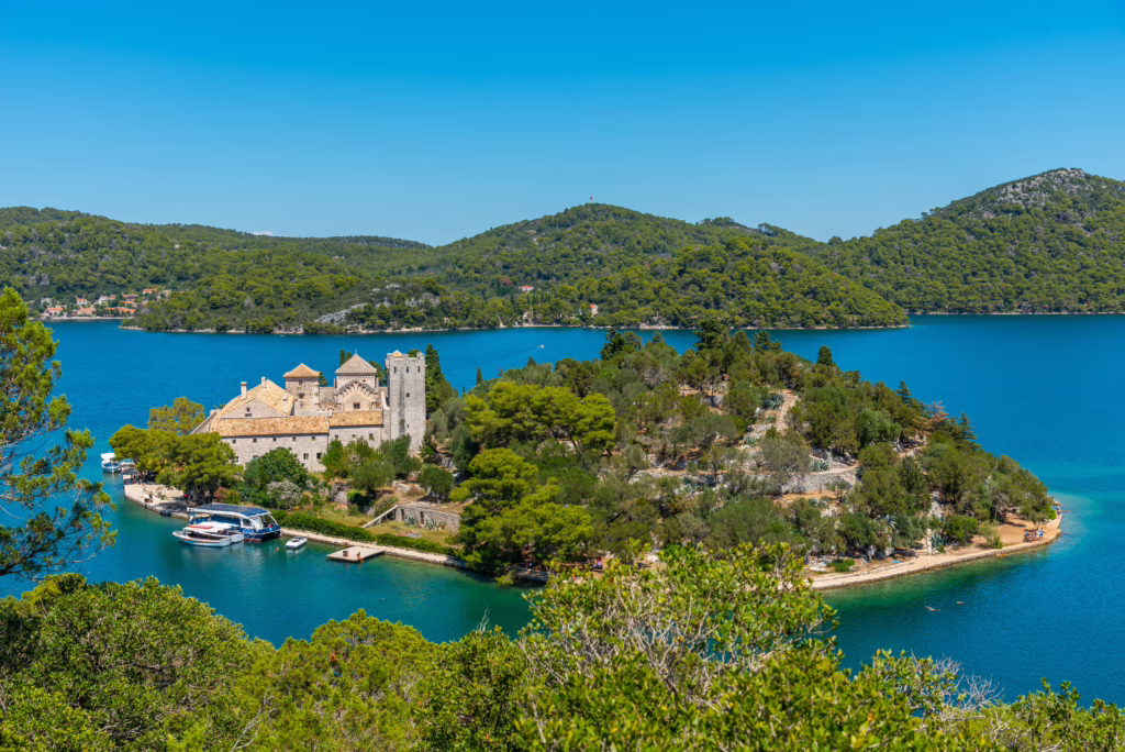 view of small island in mljet national national park with a stone building visible on the island, one of the most beautiful places croatia things to do
