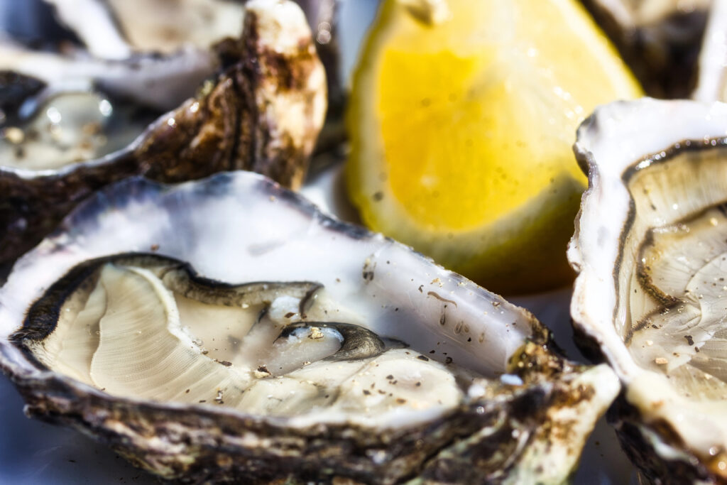 close up of oysters being served with lemon