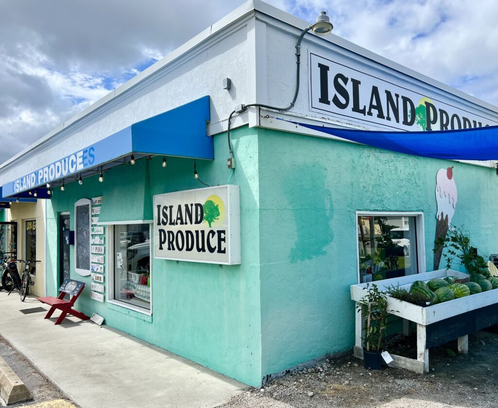 front facade of island produce store in atlantic beach north carolina, painted teal