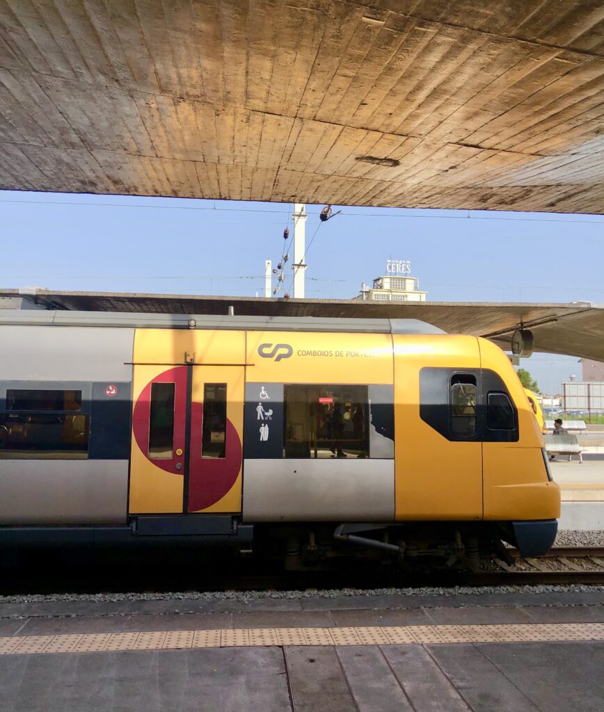 yellow coimbos de portugal train pulled in porto campanha station, as snapped when traveling from lisbon to porto by train