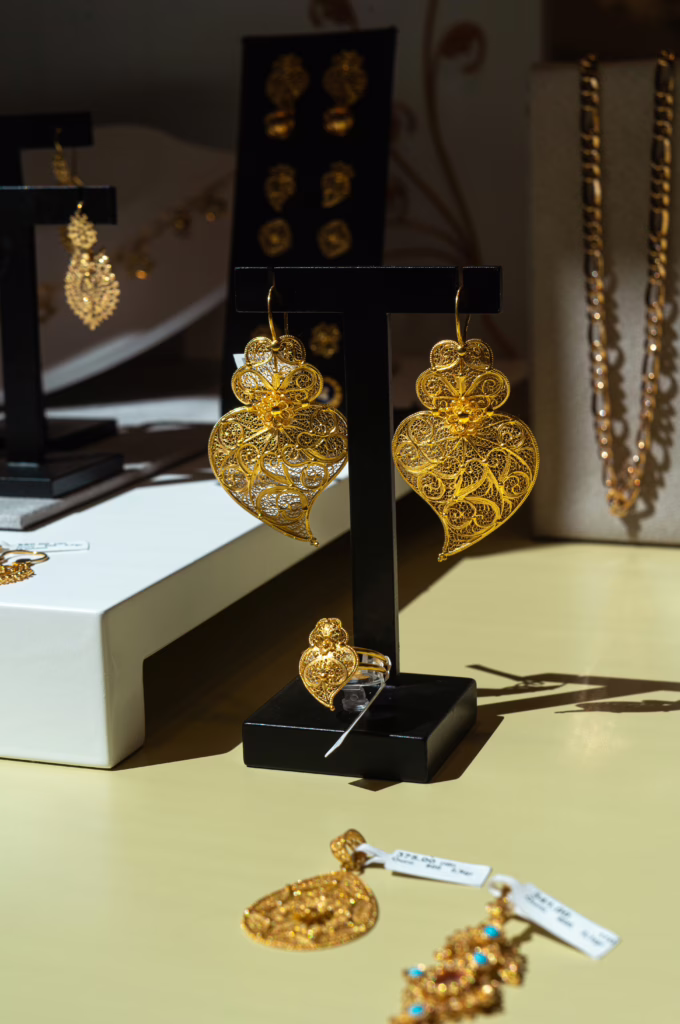 gold filigree jewelry on display in a shop window