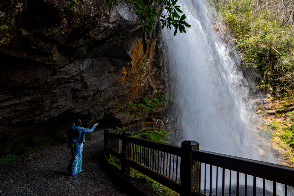 kate storm and her toddler walking on a trail behind dry falls north carolina