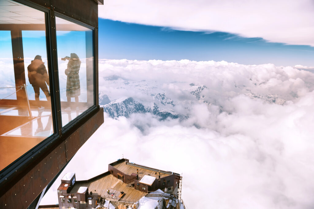 panoramic cube with travelers inside overseeing the alps in chamonix france, one of the best snowy places to visit in europe winter