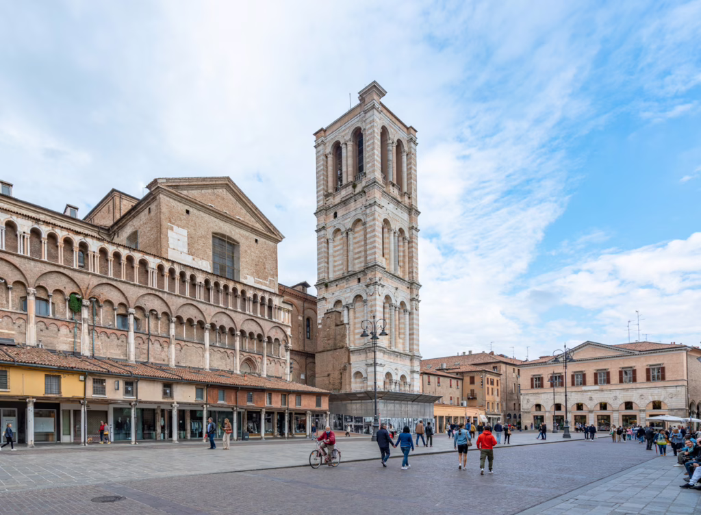 cathedral and bell tower in ferrara italy as seen from across the square