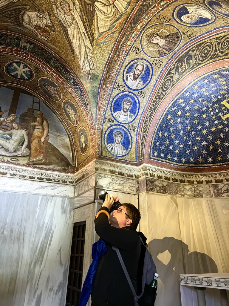 jeremy storm snapping a photo inside the mausolem of galla placidia, one of the best things to do in ravenna italy mosaics guide
