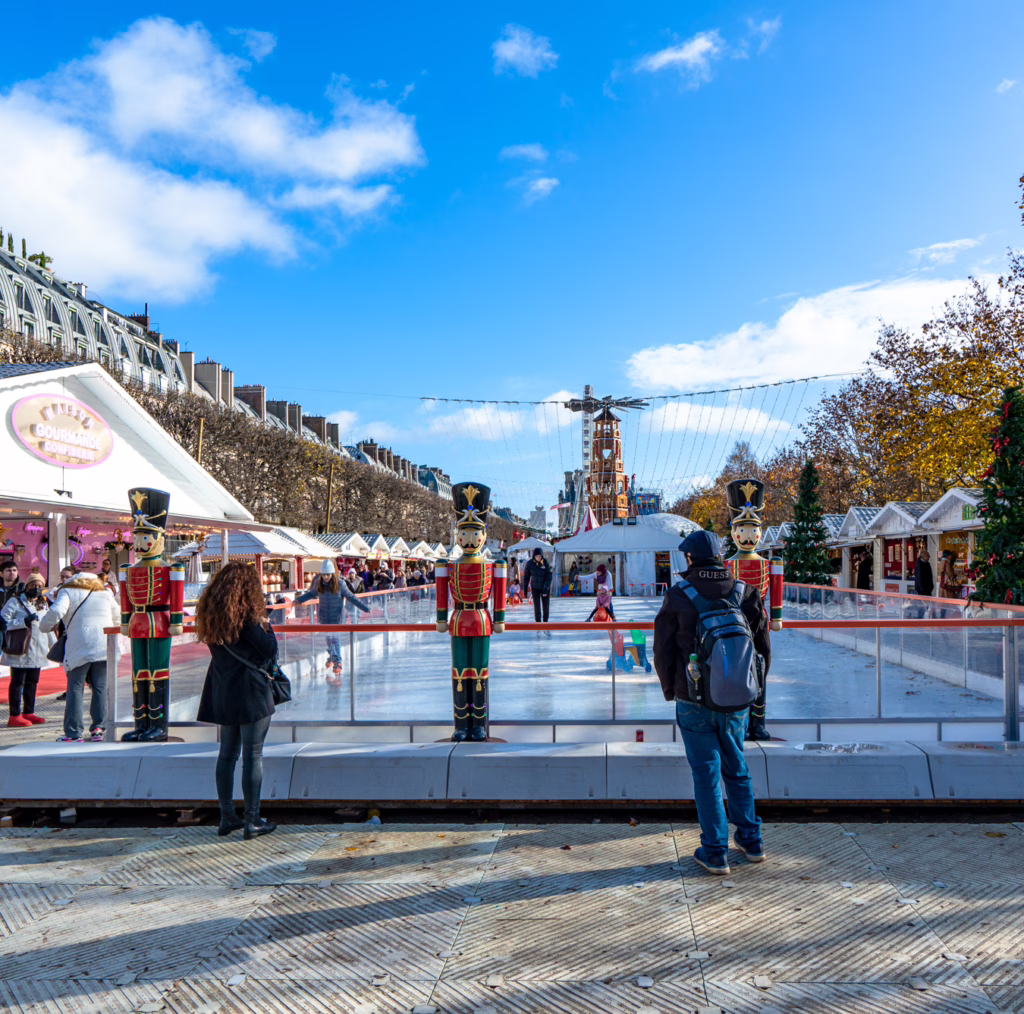 small ice skating rink at the tuileries christmas market in paris getting ready to open for the day