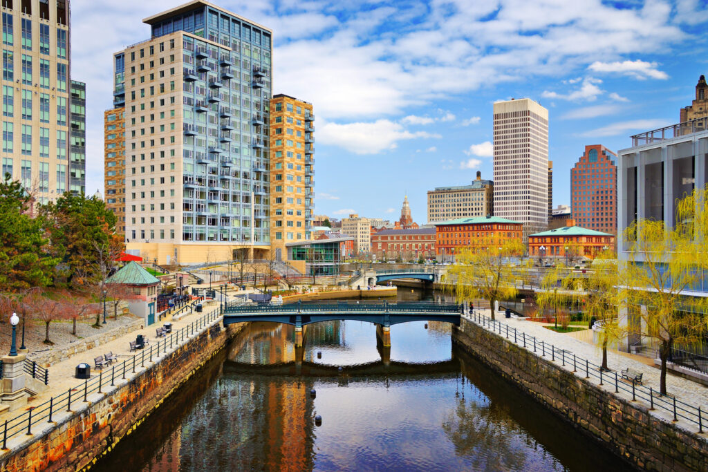 view of providence road island waterways with bridge in the center of the image and part of the skyline visible