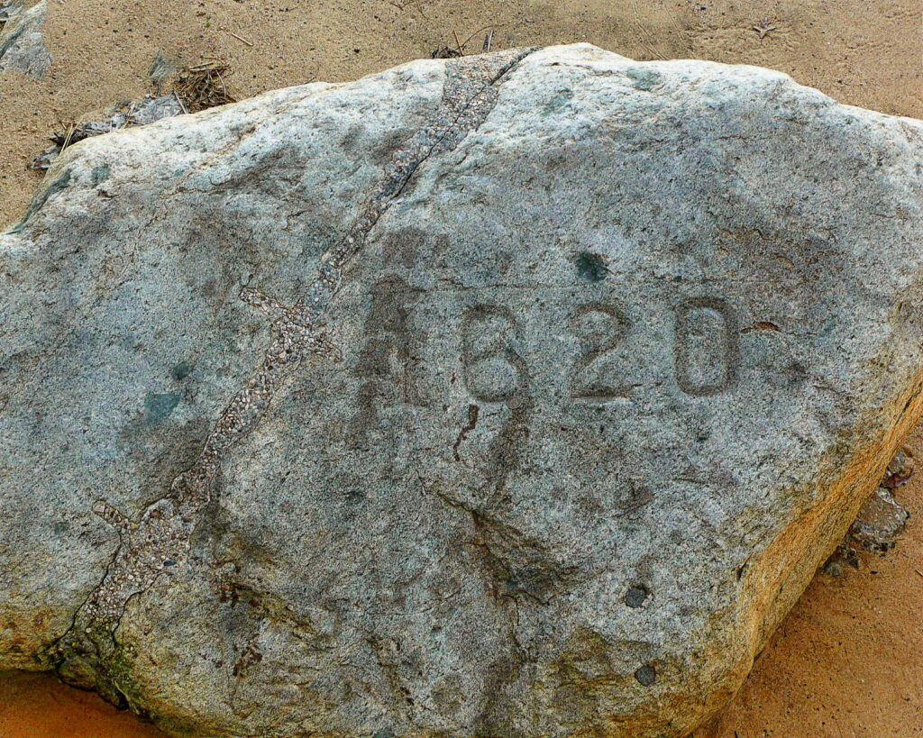 close up of plymouth rock in plymouth ma with 1620 carved into it