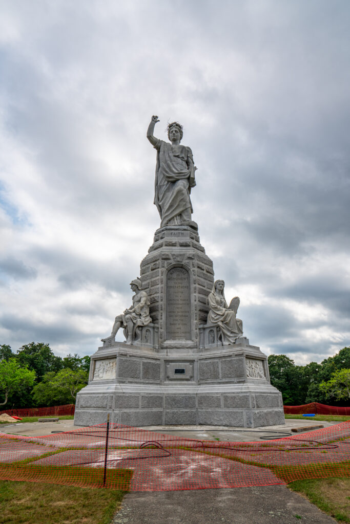 monument to the forefathers granite statue of people depicting virtues on a cloudy day, one of the popular things to see in plymouth ma