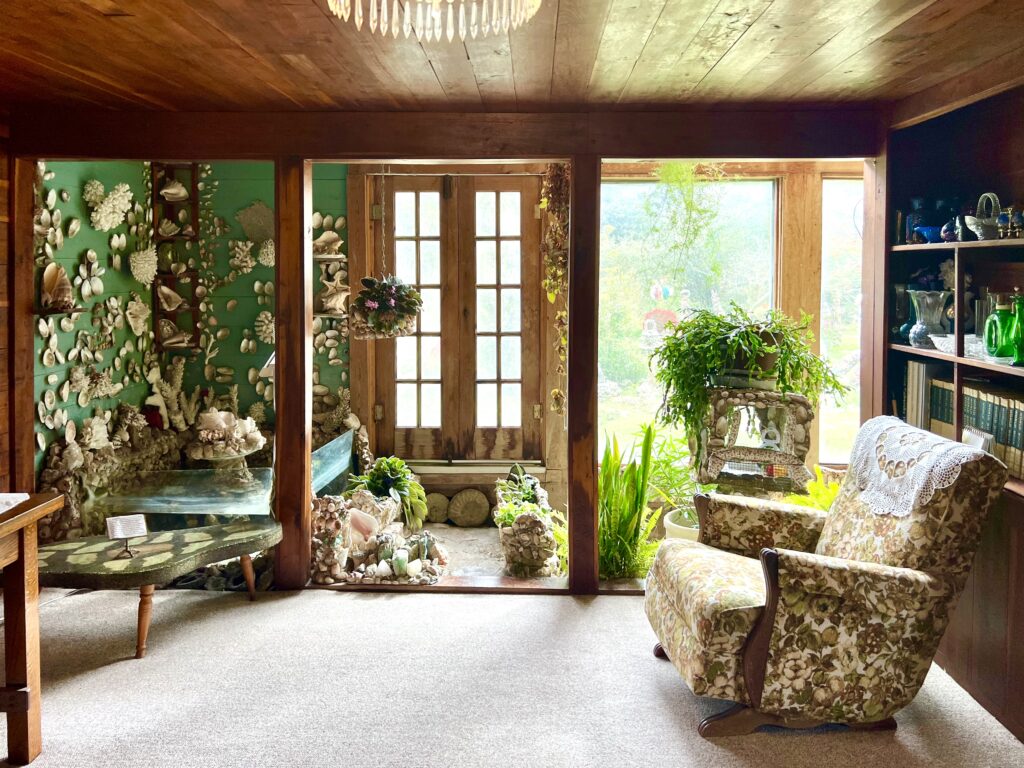 living room inside quigleys castle with plants growing inside, one of the most unique places in eureka springs weekend itinerary
